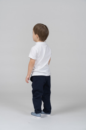 Back view of little boy standing