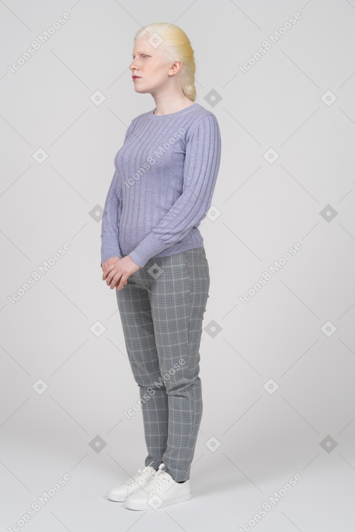 Three-quarter view of woman in casual clothes looking aside