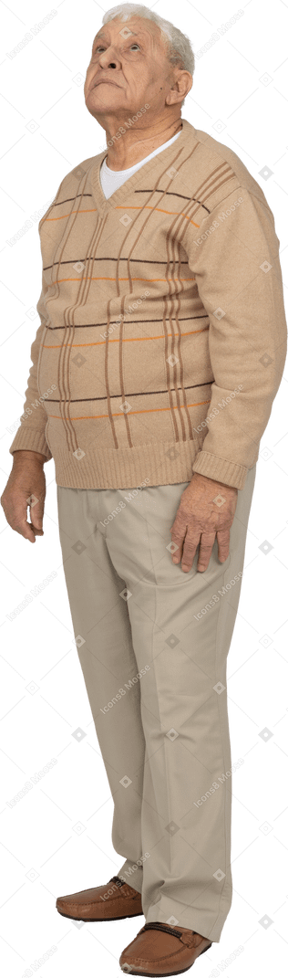 Front view of an impressed old man in casual clothes looking up