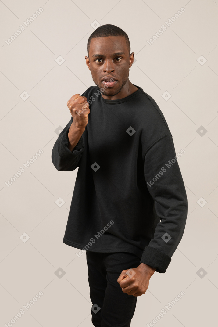 Angry man threatening to punch with fists