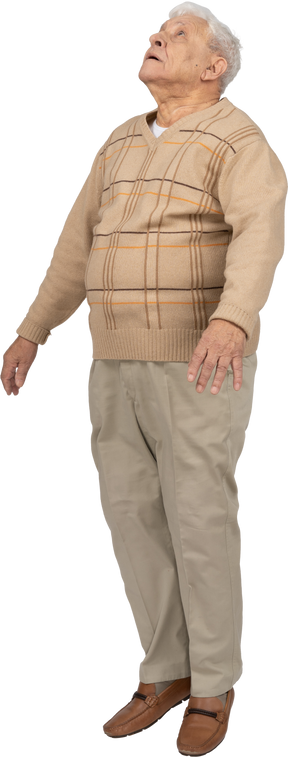Front view of an old man in casual clothes jumping