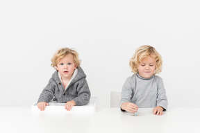 Boy playing with spinning top next to his brother