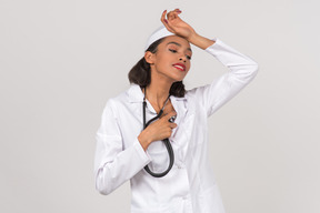 Attractive female doctor making a self check with a stethoscope