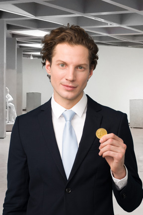 A man in a suit and tie holding a bitcoin