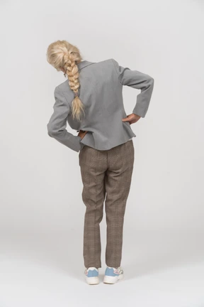 Rear view of an old lady in suit doing exercices