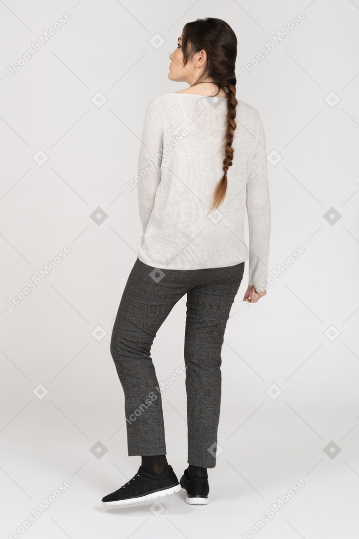 Woman with a long plait posing back to camera
