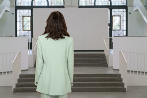 A woman standing in front of a set of stairs