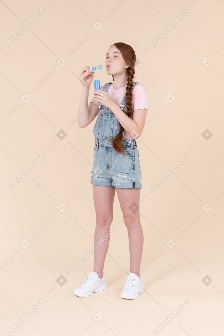 Teenage girl throwing soap bubbles