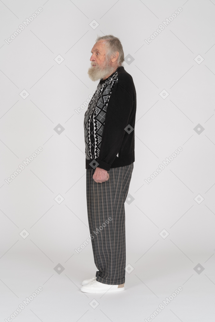 Side view of serious old man standing