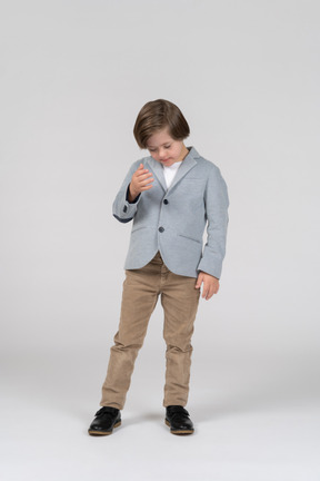 A young boy in a blue jacket and khaki pants