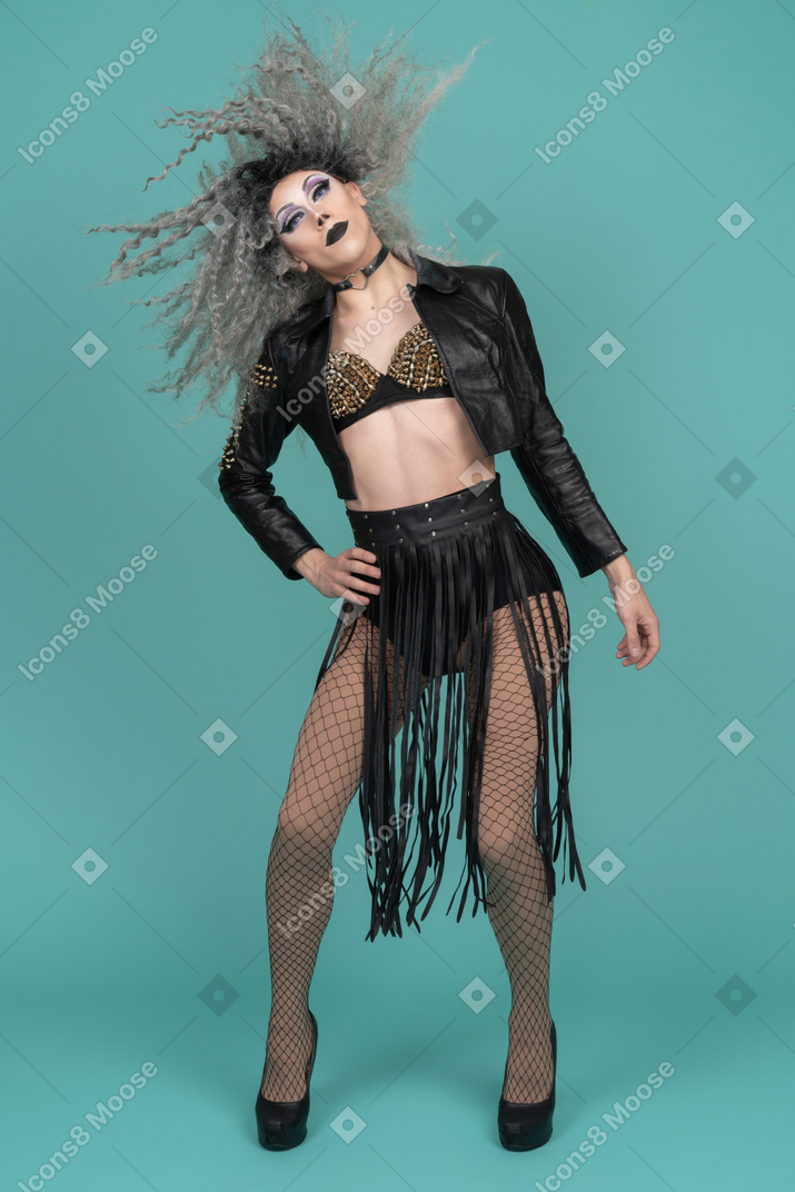 Drag queen in leather jacket whipping their hair