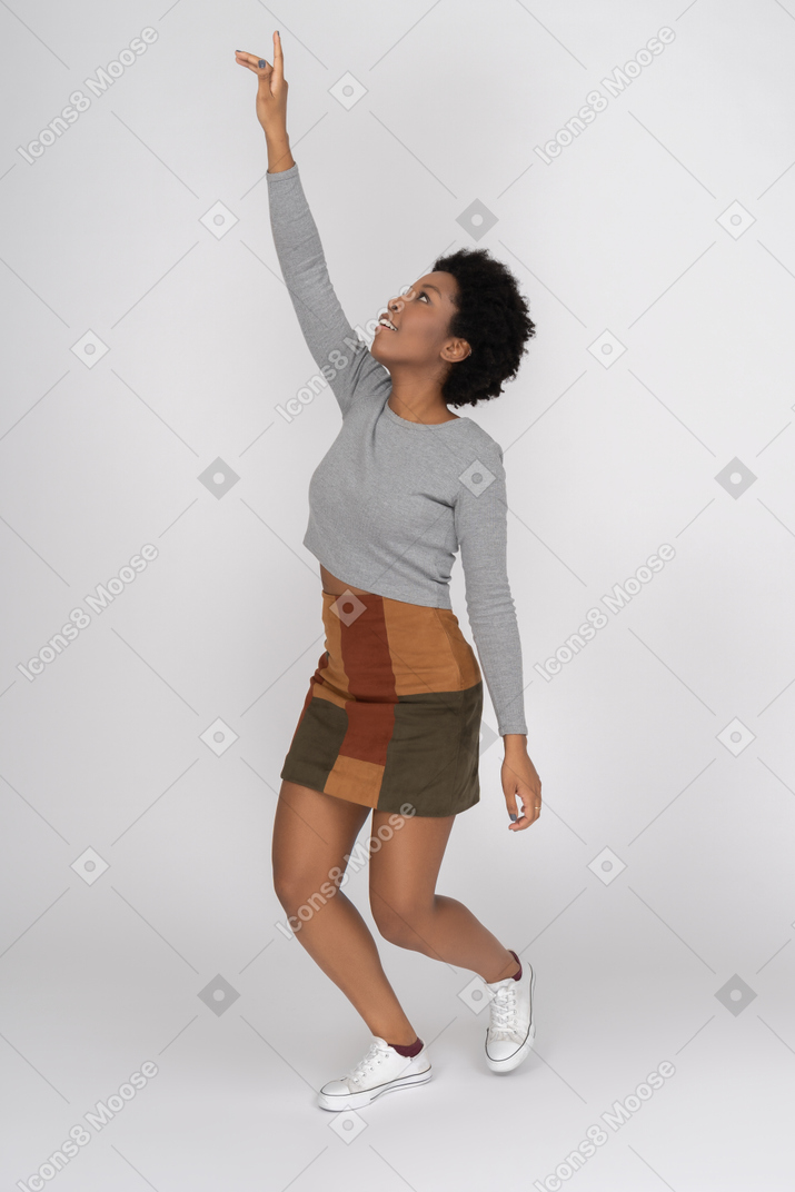 African girl pointing upwards with a finger