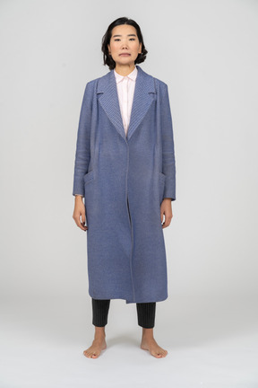 Front view of an unhappy woman in blue coat
