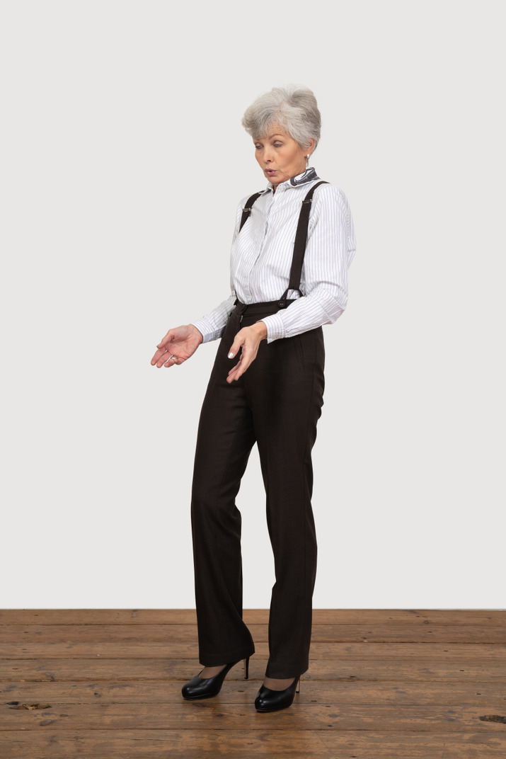 Three-quarter view of a questioning old lady outstretching her hands