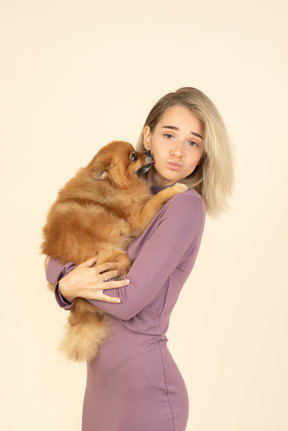 Young gir holding a spitz