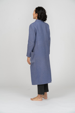 Back view of a woman in coat standing