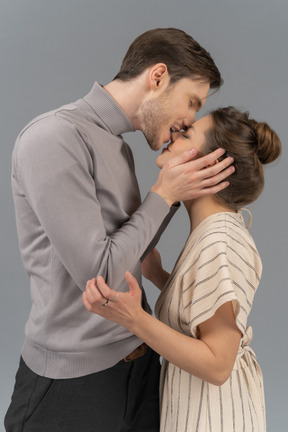 Young man biting his girlfriend's nose