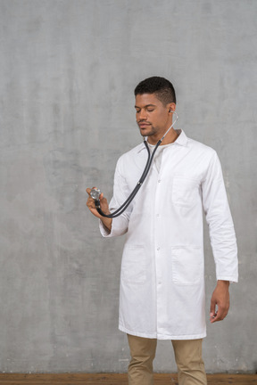 Male doctor using a stethoscope