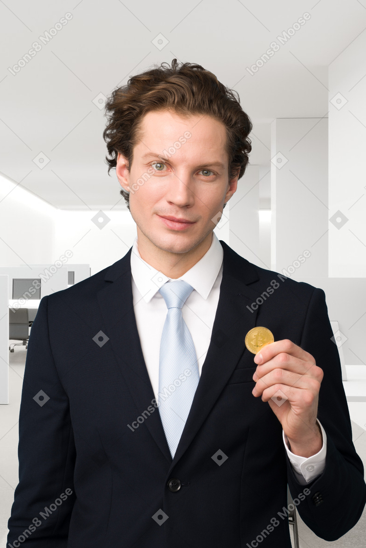 A man in a suit holding a bitcoin
