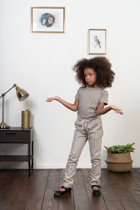 Good looking girl kid posing on the apartment background