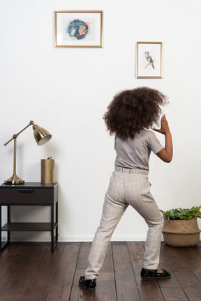 Good looking girl kid posing on the apartment background