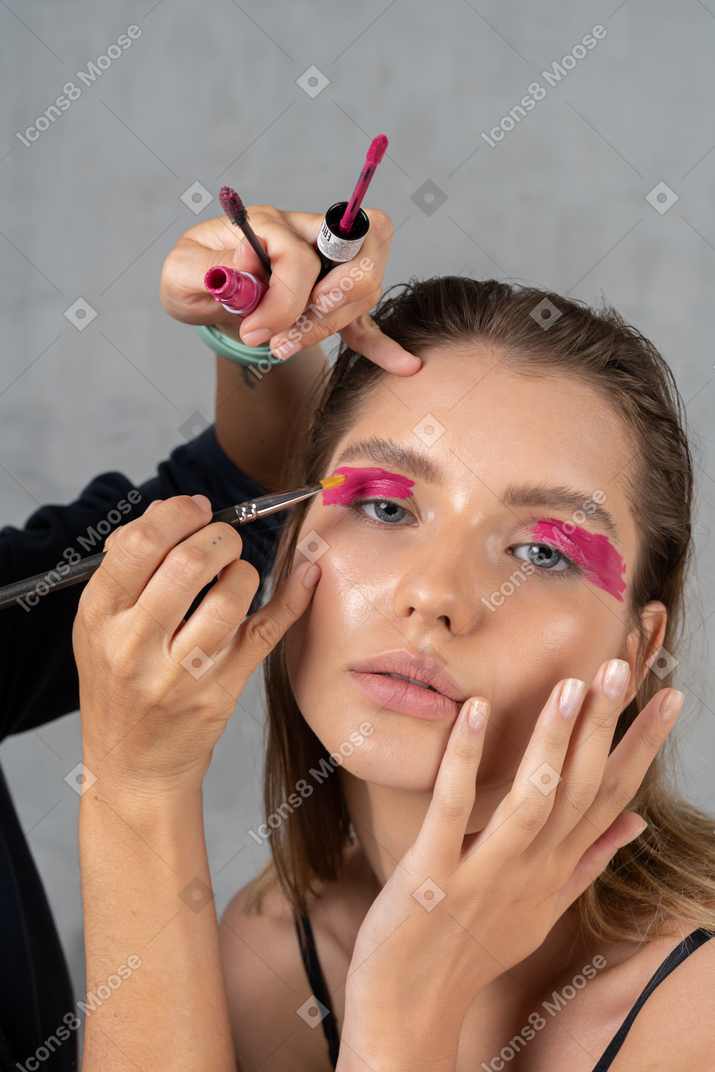 Headshot of woman having her make-up done