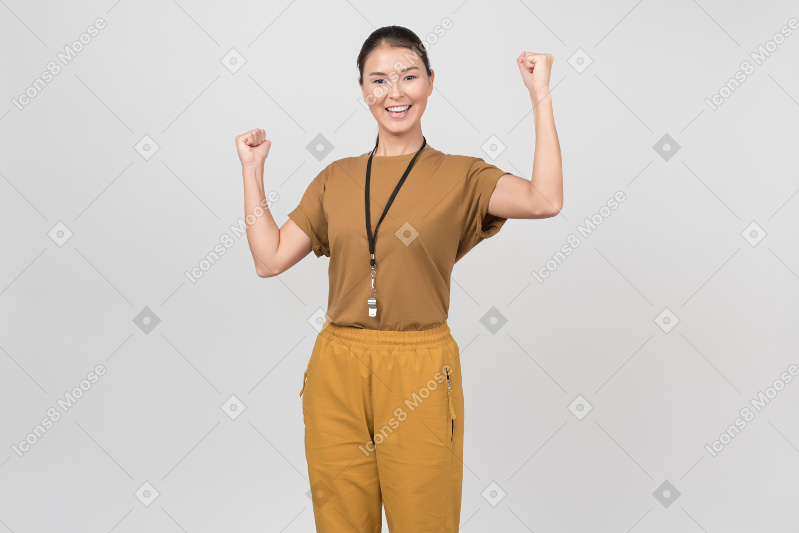 Young smiling pe teacher holding her hands up