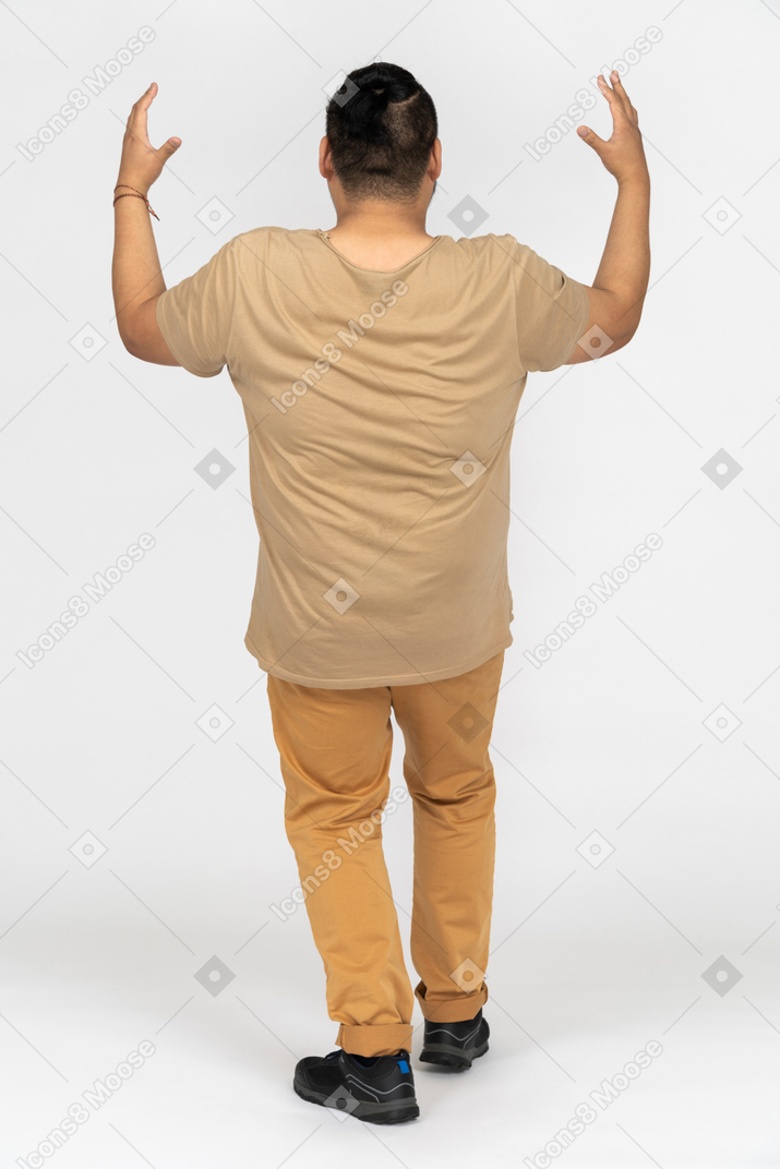Black haired asian man gesturing back to camera