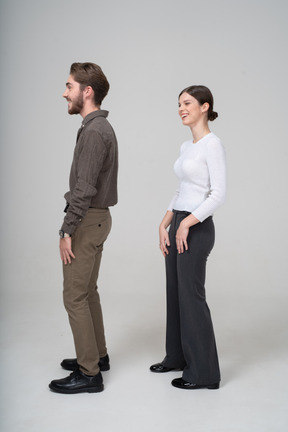 Side view of a laughing young couple in office clothing