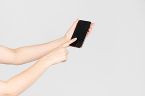 Female hands holding smartphone