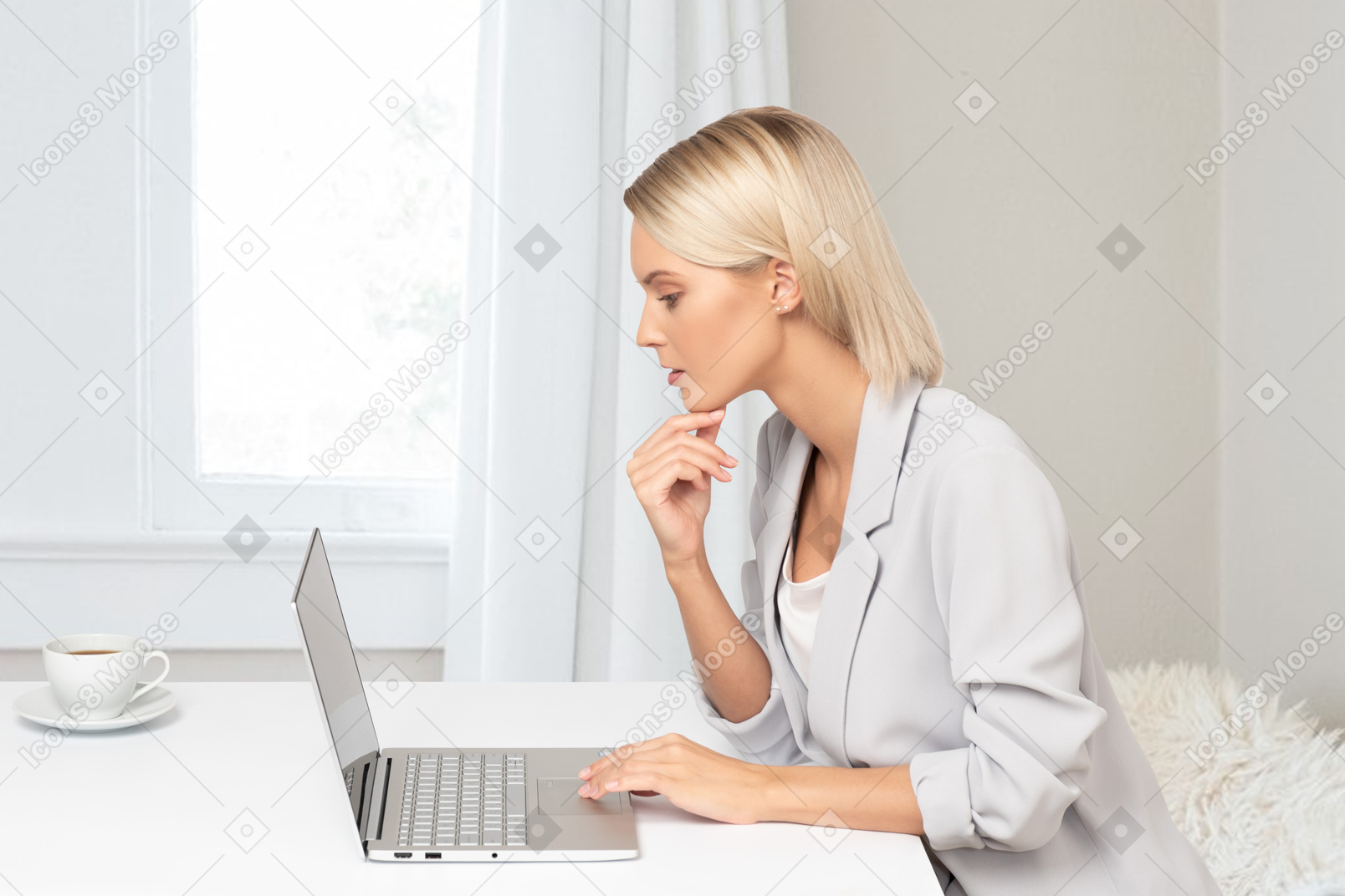 A woman sitting in front of a laptop computer