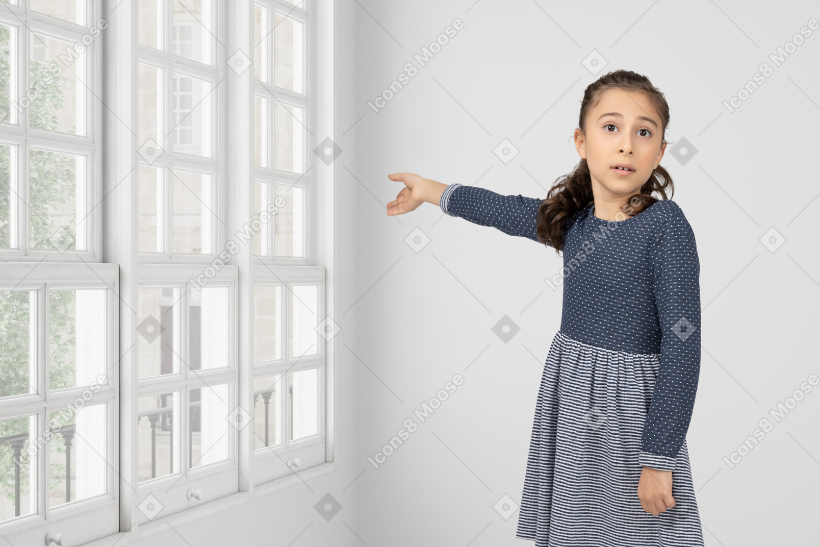 A little girl pointing at a window