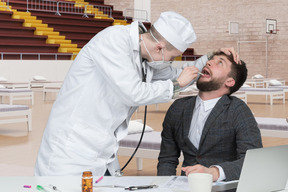 Doctor examining patient's throat