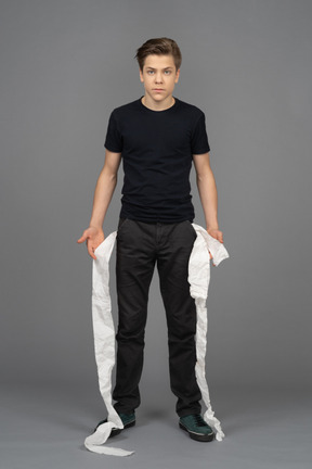 Male model guessing where toilet paper in his pockets from