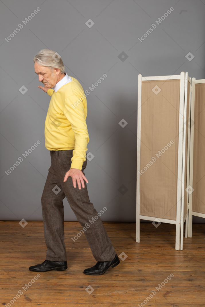 Side view of a balancing walking old man