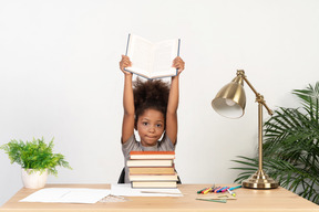 Good looking cute girl with books at the table