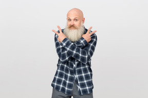 Mature bearded man showing victory gesture