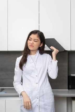 Front view of a perplexed female grimacing and holding a tablet