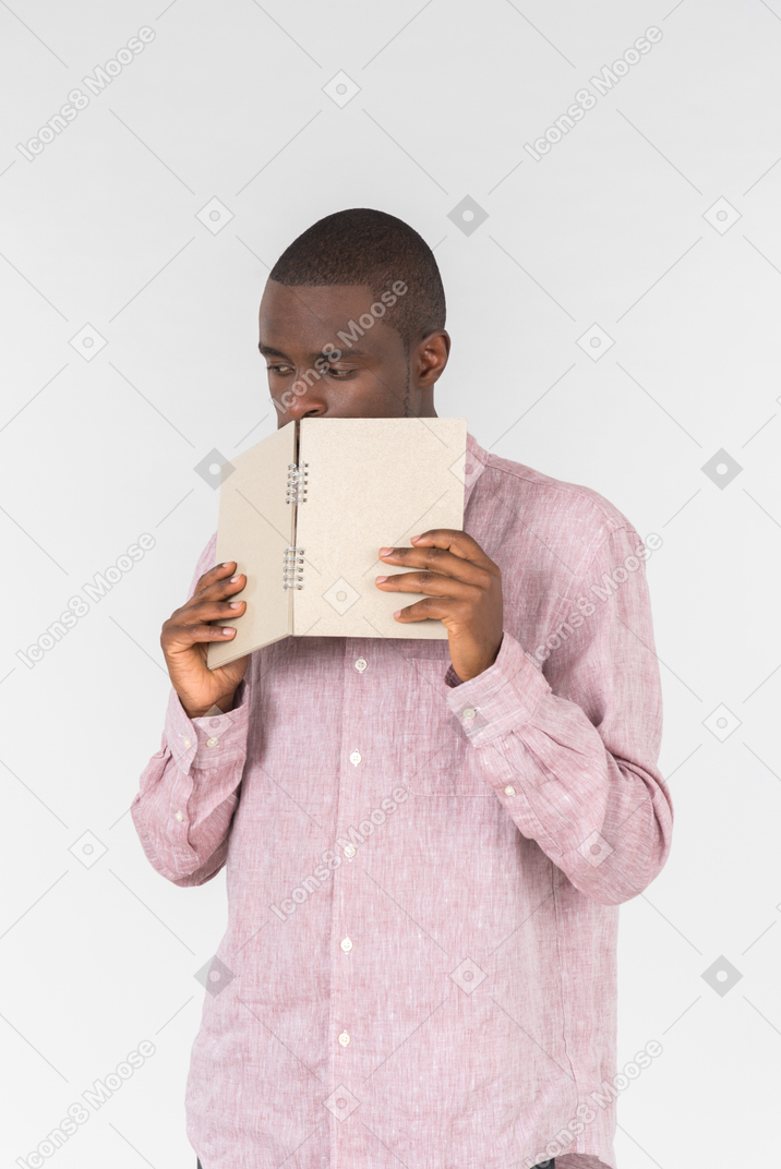 Good looking young man holding a notepad