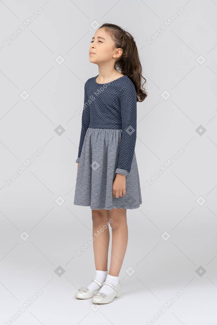 Front view of a girl standing with her eyes closed