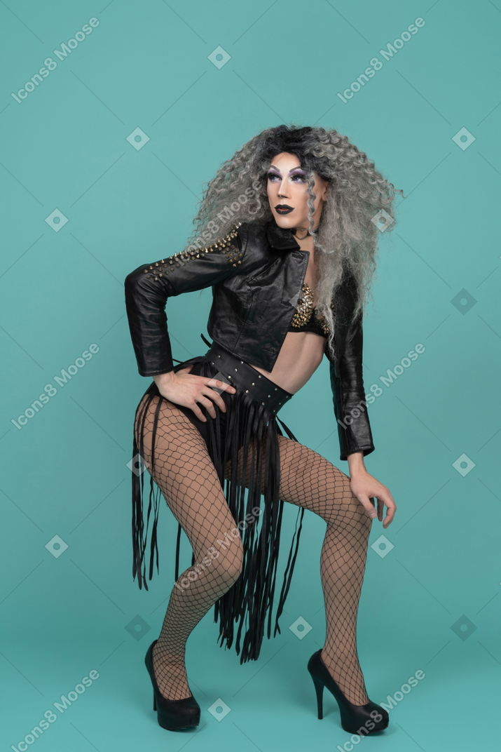 Drag queen in leather jacket looking back