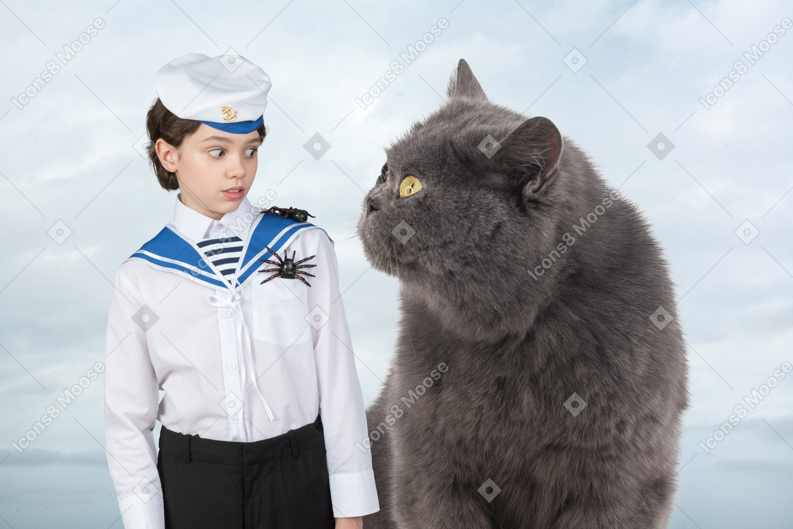 A boy in a sailor's uniform standing next to a big cat