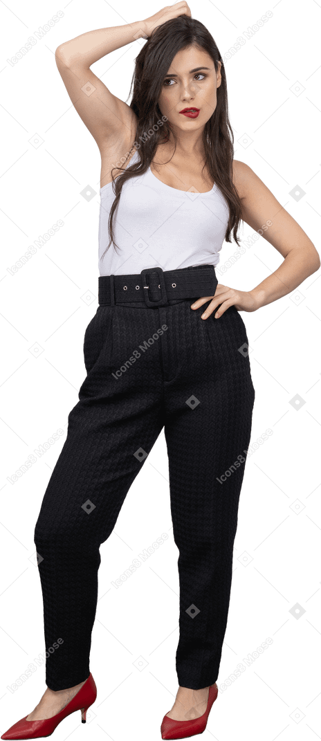 Front view of a confident young woman in office clothing posing and pouting