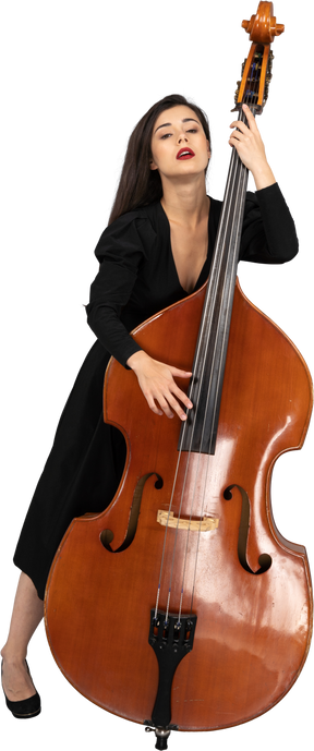 Full-length of a young lady in a black dress leaning on her double-bass