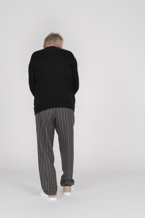 Vista posteriore dell'uomo anziano in abiti scuri