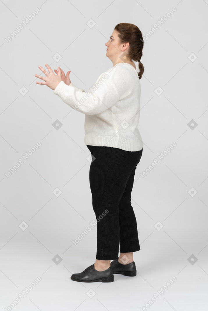 Side view of a plus size woman in casual clothes gesturing