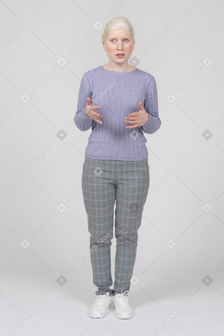 Confused young woman explaining something