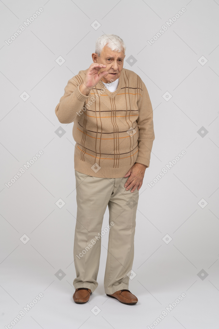 手で手を振っているカジュアルな服装の老人の正面図