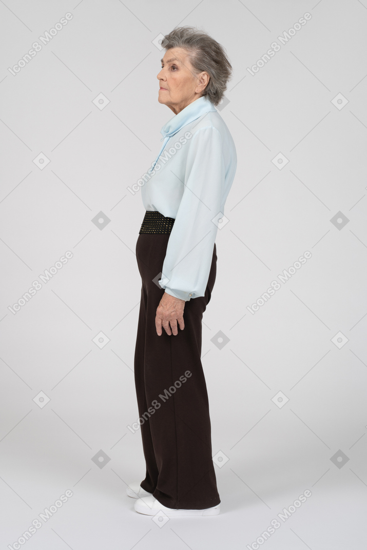 Side view of old woman standing still
