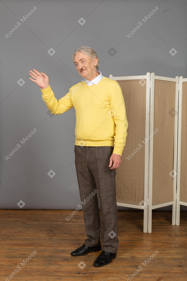 Three-quarter view of a friendly old man greeting